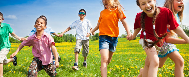 Happy Kids Running in the Grass